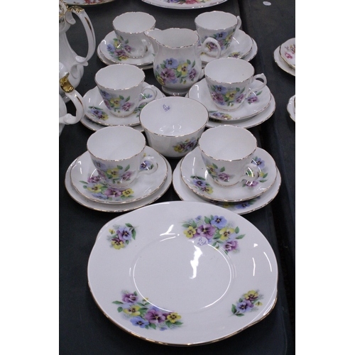 245 - A BONE CHINA TEASET WITH PANSY PATTERN TO INCLUDE A CAKE PLATE, CREAM JUG, SUGAR BOWL CUPS, SAUCERS ... 