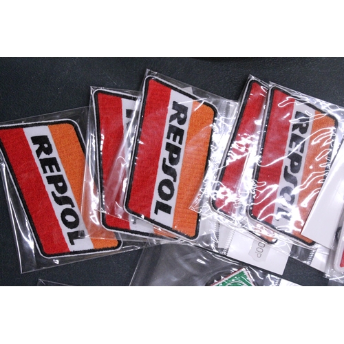 258 - TWENTY SEW ON MOTORING THEMED BADGES TO INCLUDE REPSOL, TEXACO AND ROYAL ENFIELD - ALL AS NEW IN PAC... 