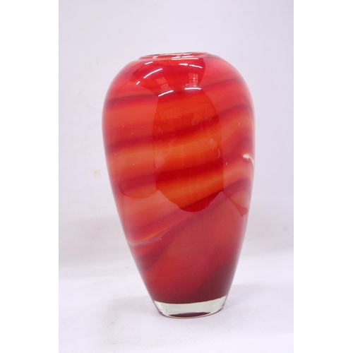 83 - A RED, ORANGE AND WHITE HEAVY GLASS VASE WITH A WHITE INTERIOR