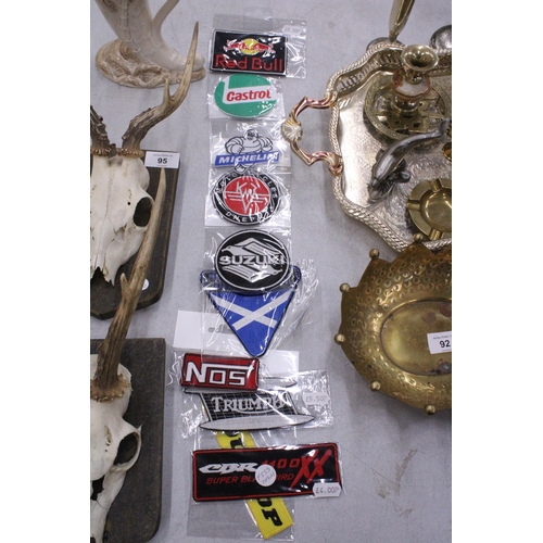 93 - A QUANTITY OF SEW ON BADGES TO INCLUDE SUZUKI, MICHELIN, TRIUMPH, ETC.,