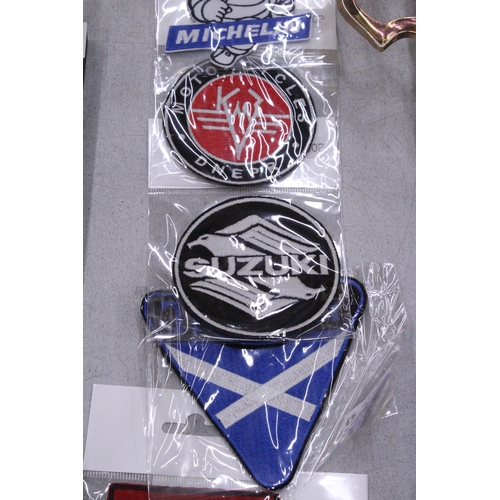 93 - A QUANTITY OF SEW ON BADGES TO INCLUDE SUZUKI, MICHELIN, TRIUMPH, ETC.,