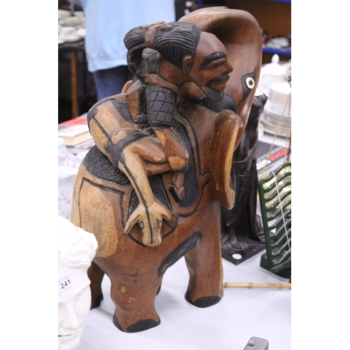 239 - A VERY HEAVY CARVED WOODEN ELEPHANT AND RIDER, HEIGHT 58CM, LENGTH APPROX 36CM