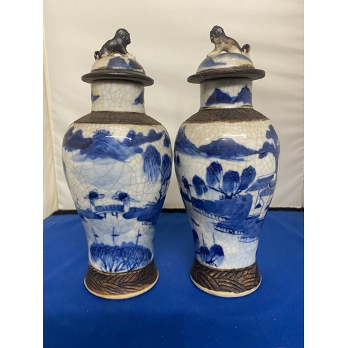 301 - A PAIR OF ANTIQUE CHINESE CRACKLE WARE VASES DECORATED WITH A BLUE PAINTED LANDSCAPE WITH A DARK BRO... 