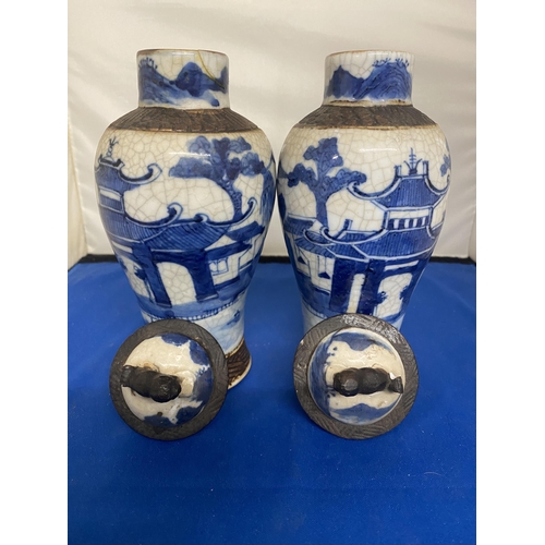 301 - A PAIR OF ANTIQUE CHINESE CRACKLE WARE VASES DECORATED WITH A BLUE PAINTED LANDSCAPE WITH A DARK BRO... 