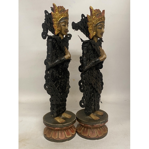 303 - A PAIR OF BALINESE TRIBAL FIGURES ON WOODEN LOTUS THRONES THEIR BODIES CONSTRUCTED FROM CHINESE COIN... 