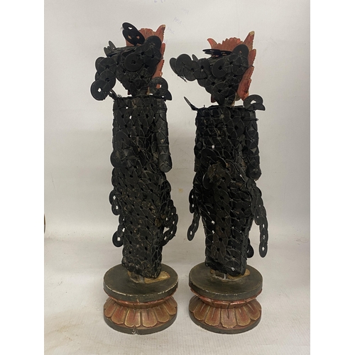 303 - A PAIR OF BALINESE TRIBAL FIGURES ON WOODEN LOTUS THRONES THEIR BODIES CONSTRUCTED FROM CHINESE COIN... 