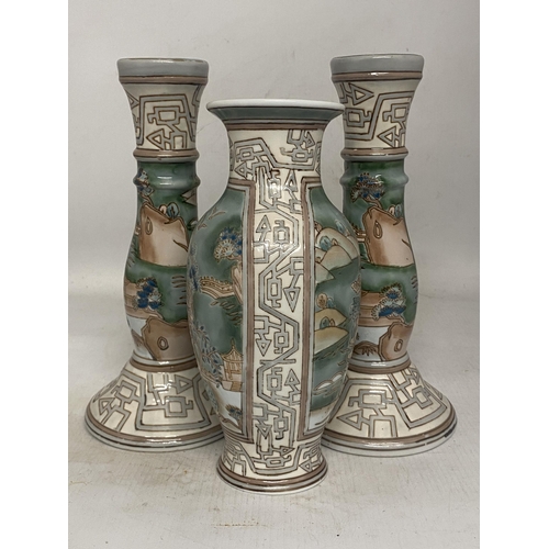 315 - A VINTAGE CHINESE ENAMELLED PORCELAIN VASE TOGETHER WITH A PAIR OF MATCHING CANDLESTICKS BOTH WITH R... 