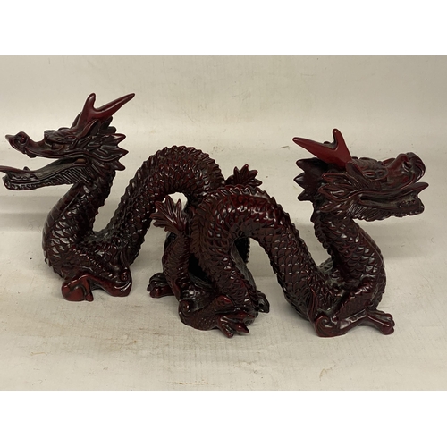 341 - A PAIR OF CHINESE RED DRAGON SCULPTURES