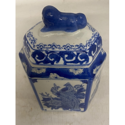 344 - A PORCELAIN CHINESE HEXAGONAL TEA CADDY WITH FOO DOG FINIAL