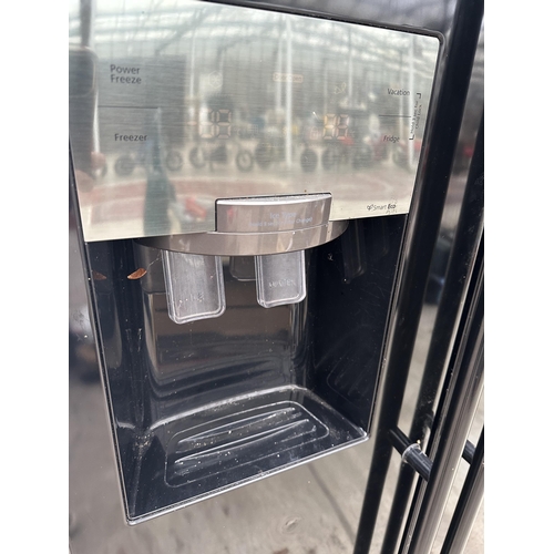 A BLACK SAMSUNG UPRIGHT AMERICAN STYLE FRIDGE FREEZER WITH WATER