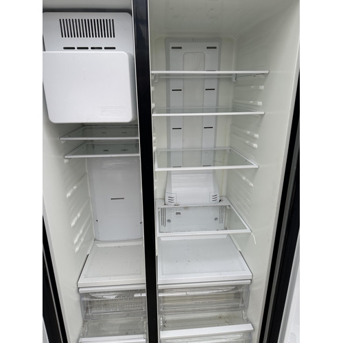 A BLACK SAMSUNG UPRIGHT AMERICAN STYLE FRIDGE FREEZER WITH WATER