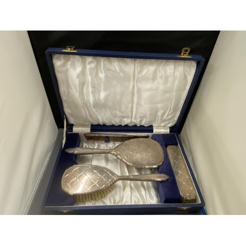 27 - A BOXED HALLMARKED BIRMINGHAM SILVER FOUR PIECE SET TO INCLUDE HAIRBRUSH, MIRROR, COMB AND CLOTHES B... 