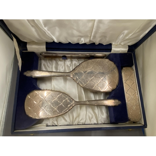 27 - A BOXED HALLMARKED BIRMINGHAM SILVER FOUR PIECE SET TO INCLUDE HAIRBRUSH, MIRROR, COMB AND CLOTHES B... 