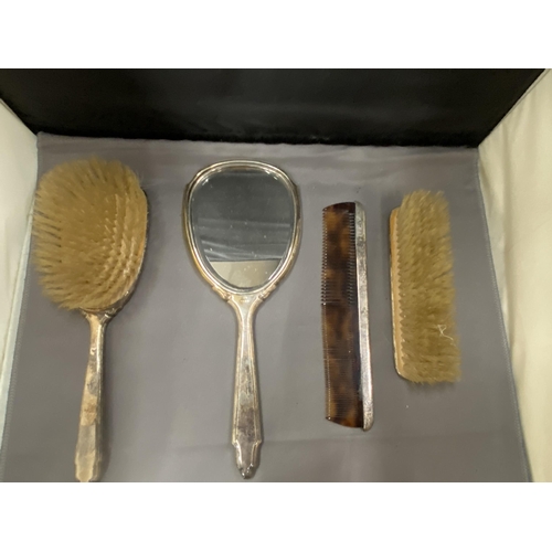 27 - A BOXED HALLMARKED BIRMINGHAM SILVER FOUR PIECE SET TO INCLUDE HAIRBRUSH, MIRROR, COMB AND CLOTHES B... 