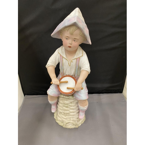 28 - A BISQUE FIGURE OF A BOY PLAYING THE DRUMS