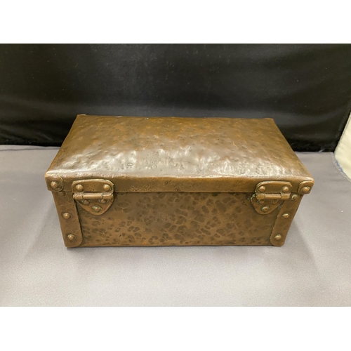 4 - AN ARTS AND CRAFTS HAMMERED COPPER AND RIVETED TRUNK STYLE BOX 16CM LONG