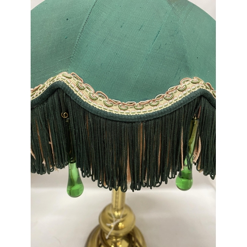 59 - A DECORATIVE BRASS LAMP BASE AND A VICTORIAN STYLE GREEN AND PINK FABRIC SHADE WITH FRINGE AND GREEN... 