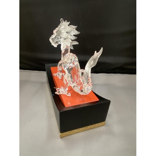 8 - A SWAROVSKI CRYSTAL DRAGON 1997 ANNUAL EDITION BY DESIGNER GABRIELE STAMEY ON A RED, BLACK AND GILDE... 