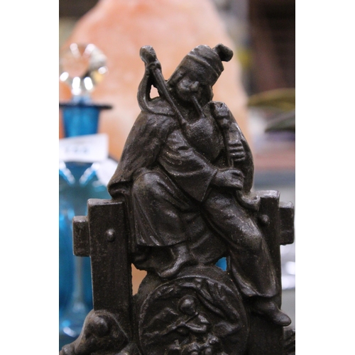 154 - A VINTAGE CAST DOORSTOP DEPICTING A PIPER AND A DOG