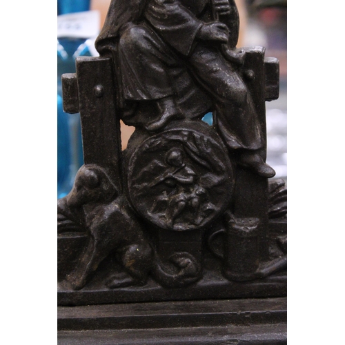 154 - A VINTAGE CAST DOORSTOP DEPICTING A PIPER AND A DOG