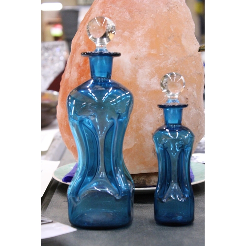 155 - TWO HOLMEGAARD KLUK-KLUK DECANTERS IN KINGFISHER BLUE WITH CLEAR STOPPERS, HEIGHTS 22CM AND 16CM