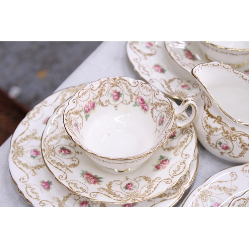 189 - SIX VINTAGE ROYAL DOULTON 'PINK ROSEBUD' TRIOS, A MILK JUG, SUGAR BOWL AND CAKE PLATE PLUS A QUANTIT... 