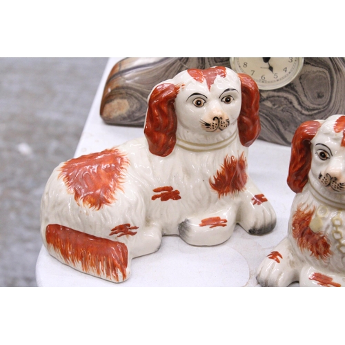 212 - A PAIR OF STAFFORDSHIRE SPANIELS, LYING DOWN