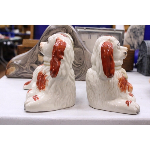 212 - A PAIR OF STAFFORDSHIRE SPANIELS, LYING DOWN