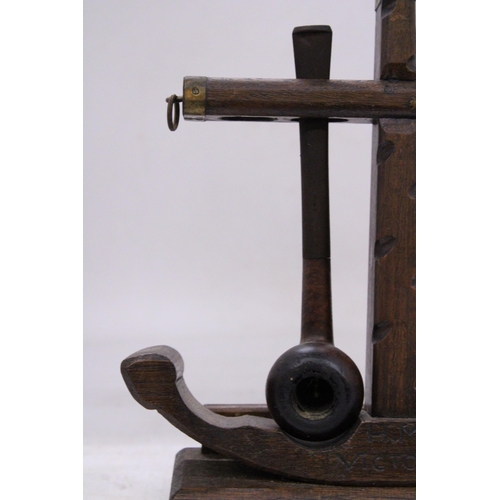 238 - A VINTAGE WOODEN PIPE HOLDER WITH PIPES