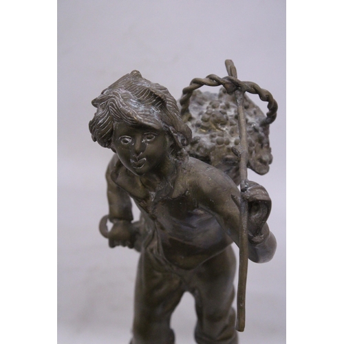 239 - A VINTAGE BRASS SCULPTURE OF A BOY WITH A BASKET, HEIGHT 35CM