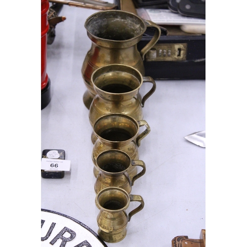 64 - A BRASS SET OF FIVE MEASURING TANKARDS