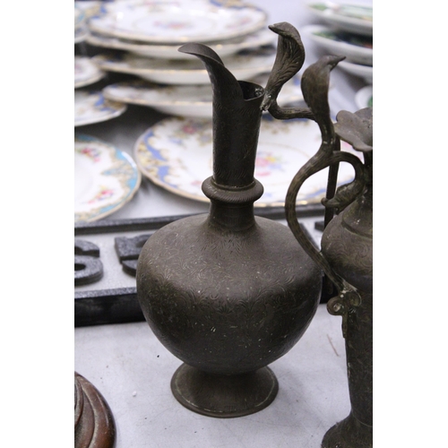 68 - A PAIR OF INDIAN BRASS ENGRAVED EWERS WITH COBRA HANDLES TOGETHER WITH A BRASS ENGRAVED URN VASE WIT... 