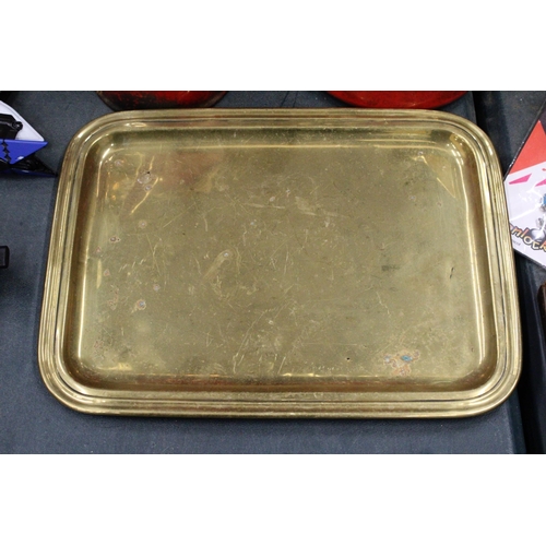 291 - AN ORNATE BRASS WALL PLAQUE AND A VICTORIAN BRASS TRAY