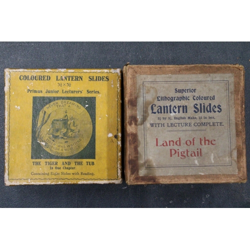 299 - TWO BOXES OF MAGIC LANTERN SLIDES - 'THE TIGER AND THE TUB' AND 'THE LAND OF THE PIGTAIL'