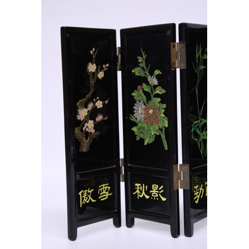 389 - A BLACK LACQUER HANDPAINTED FOLDING SCREEN