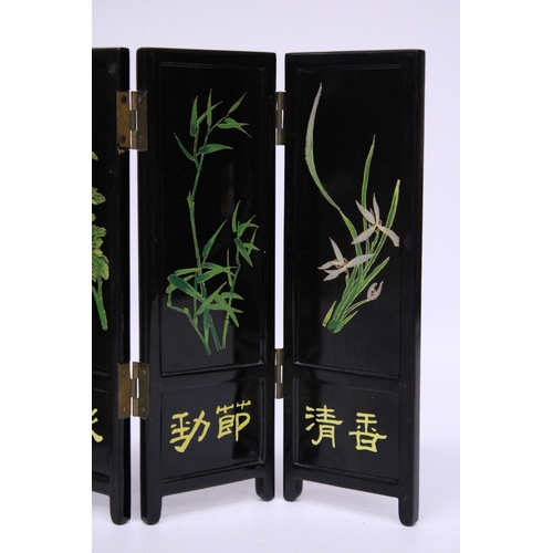 389 - A BLACK LACQUER HANDPAINTED FOLDING SCREEN