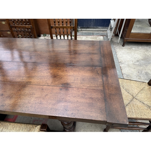 3111 - AN OAK JACOBEAN STYLE SIX LEG REFECTORY DINING TABLE 96