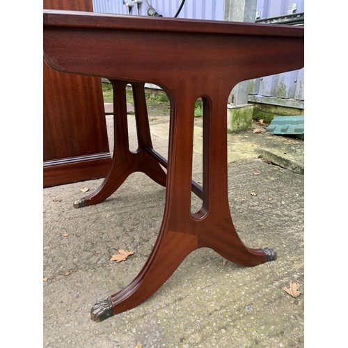 3123 - A MAHOGANY AND CROSS BANDED LAMP TABLE ENCLOSING DRAWER AND MAGAZINE RACK