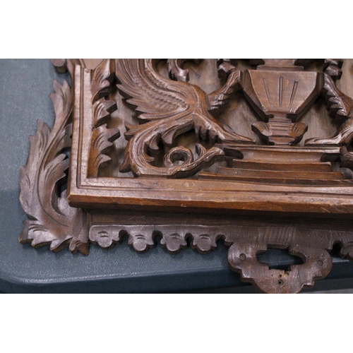 216 - A CARVED MAHOGANY WALL HANGING MAGAZINE/LETTER RACK WITH GRIFFIN DESIGN, 36CM X 40CM