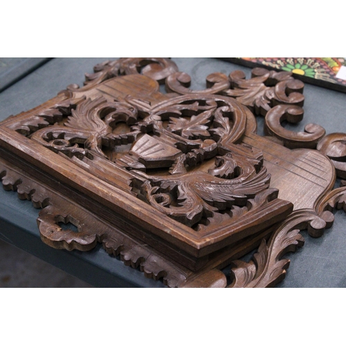 216 - A CARVED MAHOGANY WALL HANGING MAGAZINE/LETTER RACK WITH GRIFFIN DESIGN, 36CM X 40CM