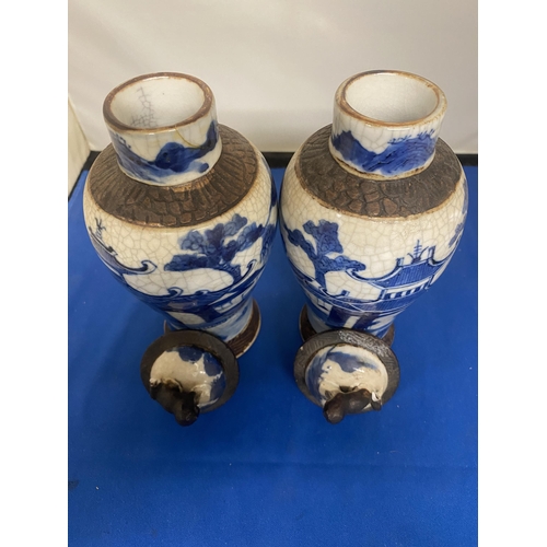 301 - A PAIR OF ANTIQUE CHINESE CRACKLE WARE VASES DECORATED WITH A BLUE PAINTED LANDSCAPE WITH A DARK BRO... 