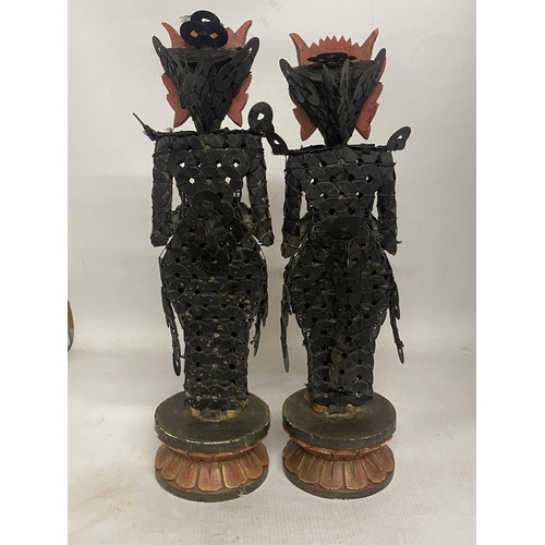 303 - A PAIR OF BALINESE TRIBAL FIGURES ON WOODEN LOTUS THRONES THEIR BODIES CONSTRUCTED FROM CHINESE COIN... 