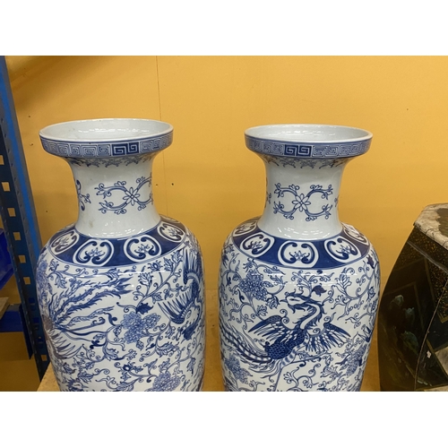 383 - A PAIR OF ORIENTAL STYLE BLUE AND WHITE CHINOISERIE VASES - 61.5 CM