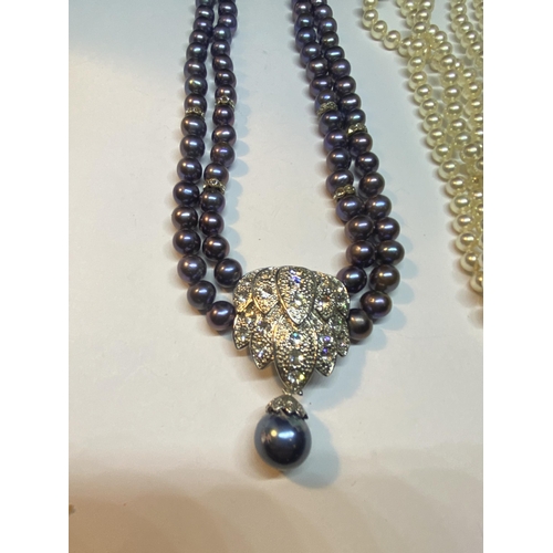 532 - TWO PEARL NECKLACES ONE WITH DOUBLE STRAND PURPLE COLOURED IN A PRESENTATION BOX THE OTHER A TRIPLE ... 