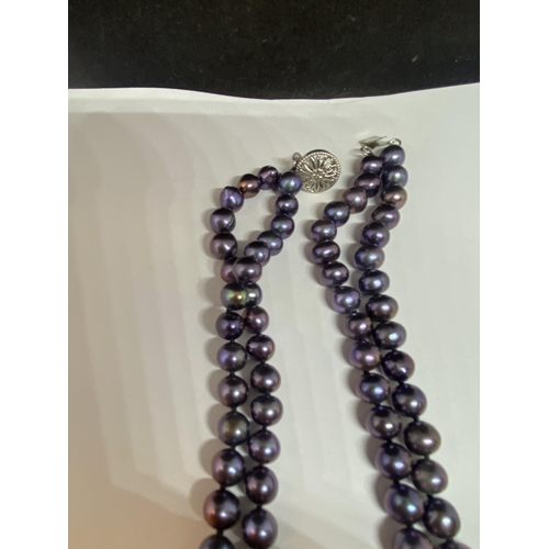 532 - TWO PEARL NECKLACES ONE WITH DOUBLE STRAND PURPLE COLOURED IN A PRESENTATION BOX THE OTHER A TRIPLE ... 