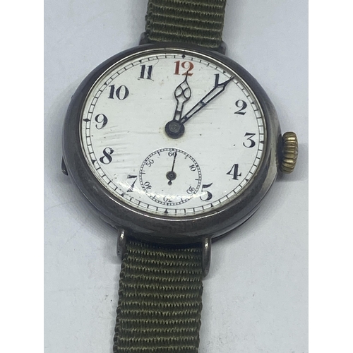 603 - A MARKED 925 SILVER WATCH WITH WHITE ENAMEL FACE AND SUB DIAL. GBREEN CANVAS STRAP SEEN WORKING BUT ... 