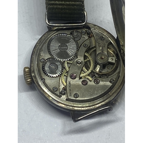 603 - A MARKED 925 SILVER WATCH WITH WHITE ENAMEL FACE AND SUB DIAL. GBREEN CANVAS STRAP SEEN WORKING BUT ... 