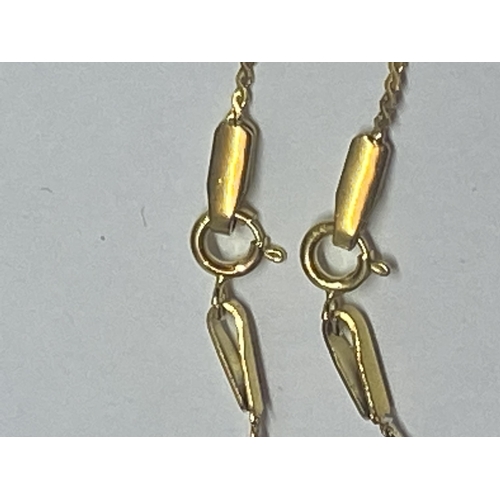 640 - TWO YELLOW METAL NECKLACES WITH PEARL STYLE INITIAL PENDANTS T AND S