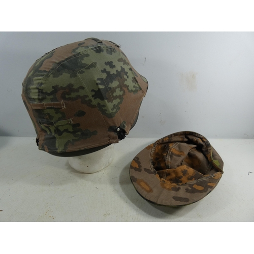 310 - A REENACTORS NAZI GERMANY HELMET WITH LEATHER LINING AND CAMOUFLAGE COVER, AND A CAMOUFLAGE CAP