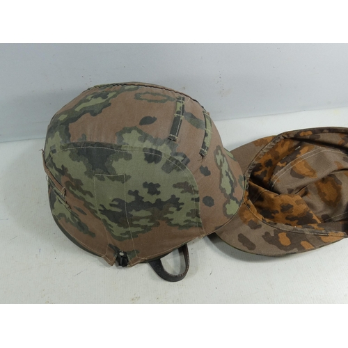 310 - A REENACTORS NAZI GERMANY HELMET WITH LEATHER LINING AND CAMOUFLAGE COVER, AND A CAMOUFLAGE CAP